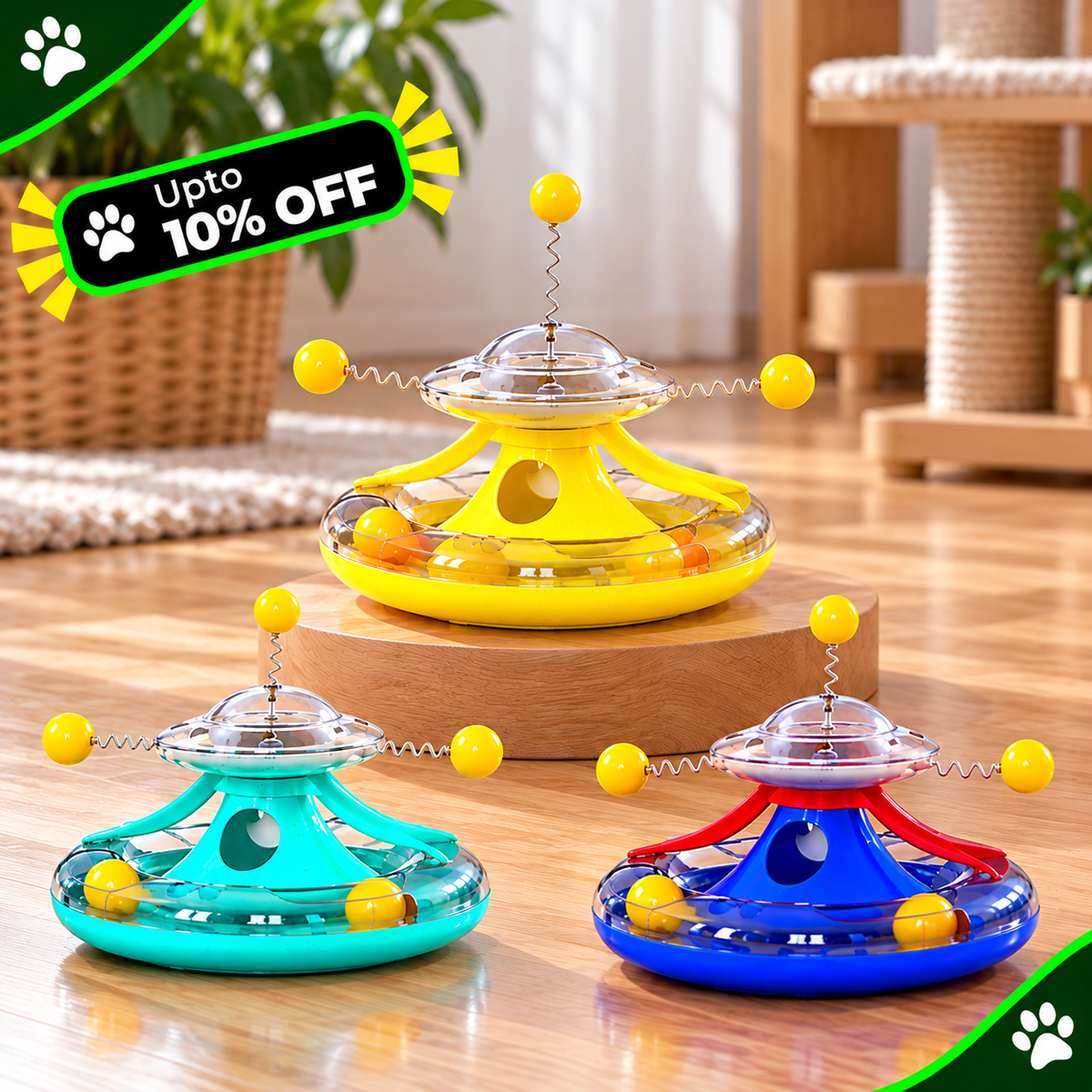 Three colorful cat toy frisbe toys in yellow, teal, and blue, displayed on wooden risers in a home setting with a green 'Upto 10% OFF' promotional banner overlay.