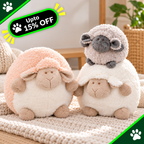 Two plush sheep toys in a cozy indoor setting. One sheep has a peach-pink fluffy hood and cream body, while the other has a light gray hood and white body, with a small gray sheep sitting on top of each.